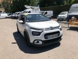 a small white car parked in a parking lot