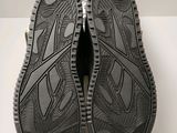 the soles of a pair of black shoes are shown on a white surface