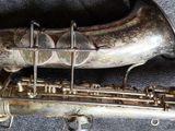 a silver saxophone that is sitting on the floor