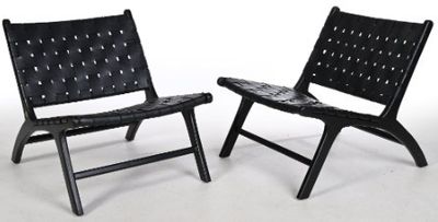 pair of black leather folding chairs on a white background