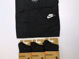 a pair of black socks and a black shirt are sitting on a table