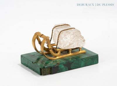 a gold and green sculpture of a horse pulling a sleigh