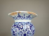 a blue and white vase sitting on top of a table