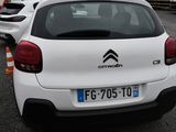 a white car parked in a parking lot next to other cars