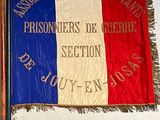 a french flag hanging on the wall next to a pencil