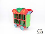 a toy shopping cart that is sitting on a white surface