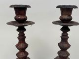 two wooden candlesticks that are standing next to each other