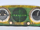 a green and gold radio sitting on top of a white table