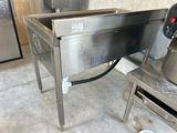 a large stainless steel sink in the middle of a kitchen