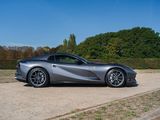the silver sports car is parked on the side of the road