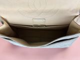 a close up of a chanel purse with a pink background