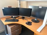 a desk with two monitors and a keyboard on it