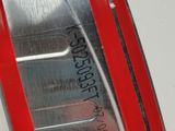 a close up of a metal object with a red stripe