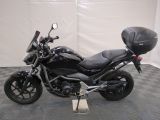 a picture of a black motorcycle parked on a checkered floor