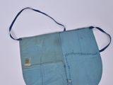 an old blue purse sitting on top of a white table