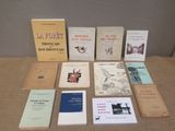 several books are sitting on a table in front of a wall