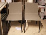 two chairs sitting next to each other in a room