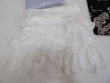 a white skirt and a bag sitting on a table