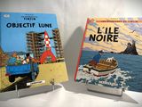 two books that are on display on a table
