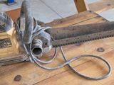a chainsaw sitting on a wooden table in a workshop