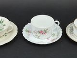 three cups and saucers are sitting on a black surface