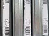several metal pipes are stacked on top of each other in a warehouse