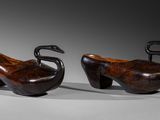 pair of carved wooden ducks on a white background