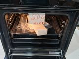 a black oven with a box of food inside of it