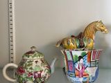 two teapots and a teapot on a glass shelf