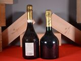 two bottles of wine sitting next to each other on a table