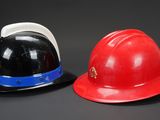 two hard hats sitting next to each other on a table
