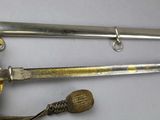 two swords that are laying next to each other