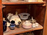 a wooden cabinet with many different items on it