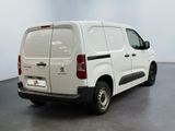 the white van is parked in the empty room of the building