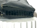 a black purse sitting on top of a white radiator