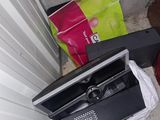 a television sitting on the floor next to a pile of luggage