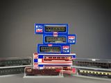 several model trains are stacked on top of each other on a table