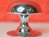a silver bell sitting on top of a white counter