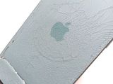 a broken apple phone sitting on top of a table