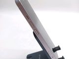 a cell phone that is on a stand on a table