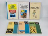 several books are lined up on a white surface