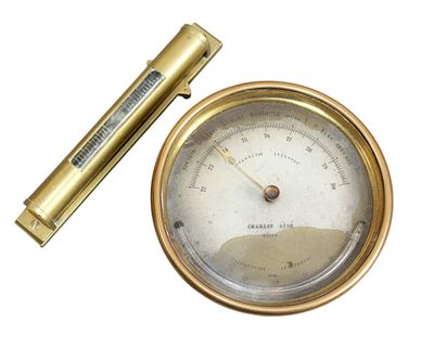 a gold clock and a pen on a white surface