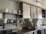 a kitchen with stainless steel cabinets and a stove