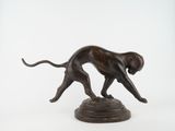bronze statue of a dog on a pedestal on a white background