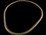 a gold necklace on a black background
