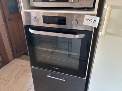 two microwaves stacked on top of each other in the kitchen