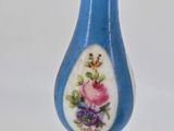 a blue vase with a floral design on it
