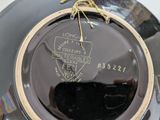 a black plate with a gold rim and a black plate with a gold rim on it