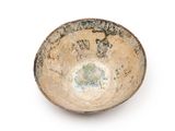 a small bowl that is sitting on a white surface