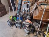a lot of clutter on the floor in the garage